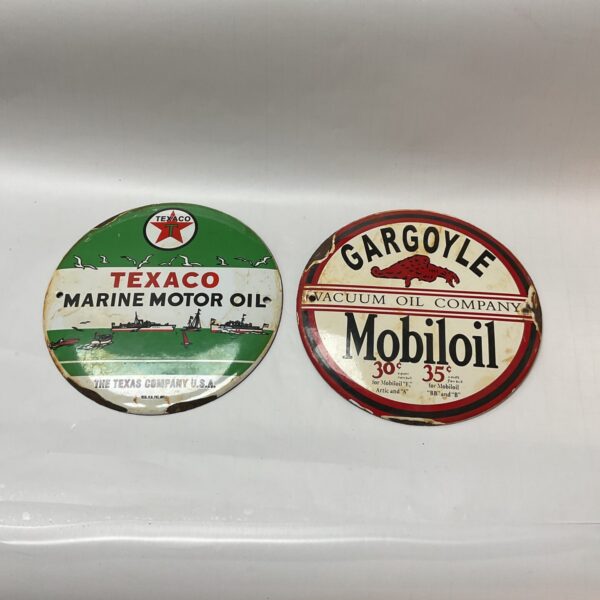 Vintage Texaco and Mobiloil metal signs for collectors.