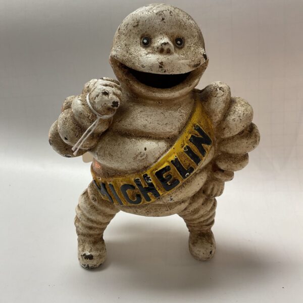 Vintage cast iron Michelin Man figurine, collectible automobilia.