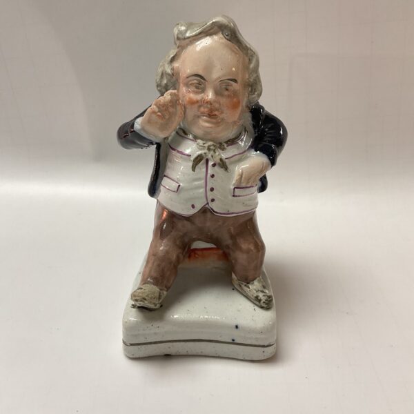 Antique Victorian Staffordshire snuff taker figure, colourful pottery collectible.