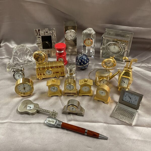 Large collection of novelty desk clocks for collectors and display.