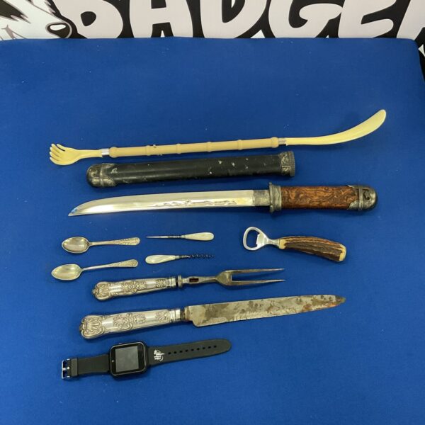 Vintage silver handled carving set with katana sword on display.