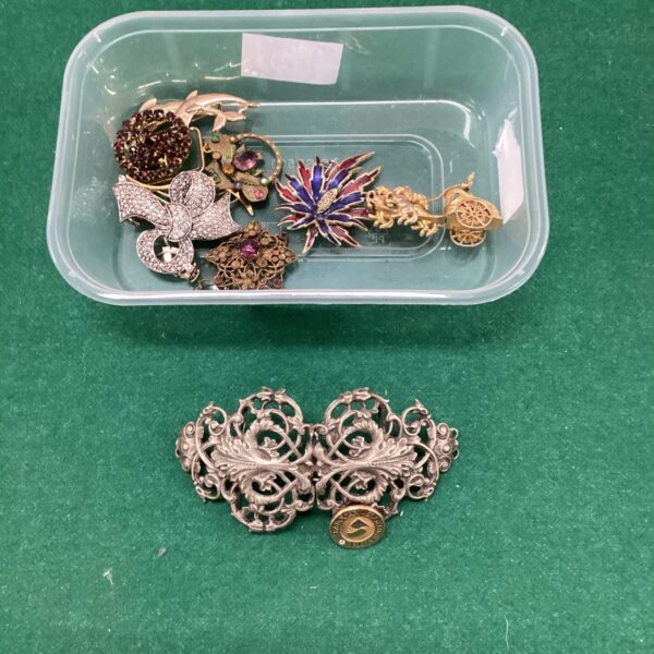 Vintage brooch lot with assorted pins and a nurse’s buckle.