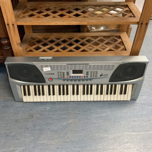 Front view of a Finetune professional keyboard with keys and controls.