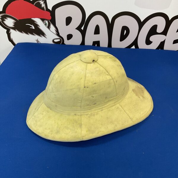 Front view of a vintage pith helmet on a blue surface.