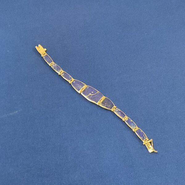 Close-up of a vintage silver lapis bracelet with blue stones.