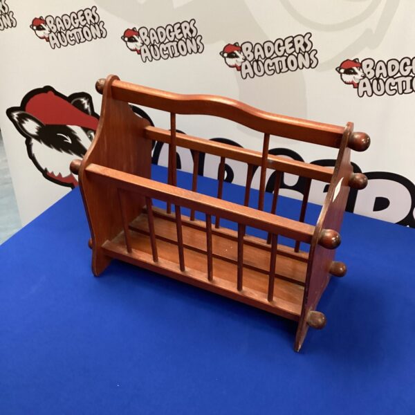 Vintage mahogany magazine rack with four compartments for storage.