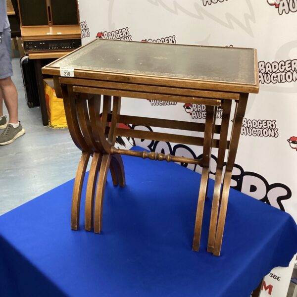 Vintage mahogany scissor legged nest of tables in a home setting.
