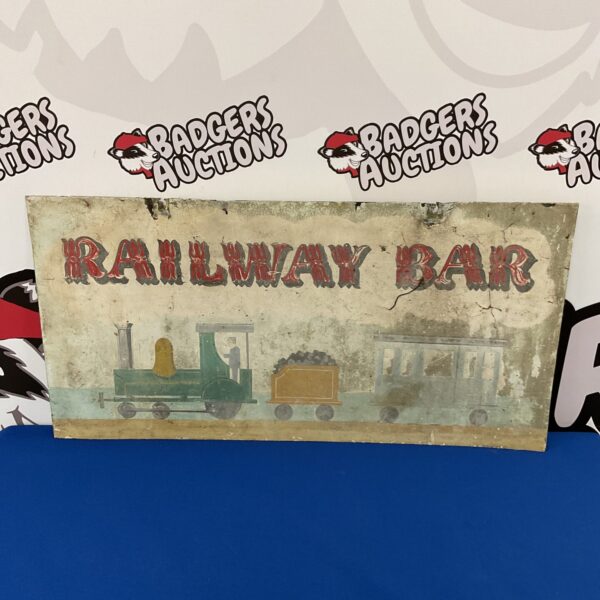 Vintage railway bar sign featuring a colourful steam train illustration.
