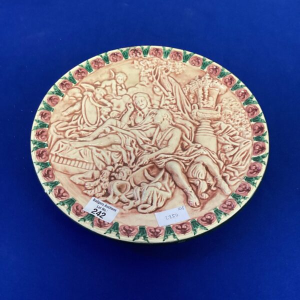 Vintage porcelain hanging plate with cherub design for wall decor.