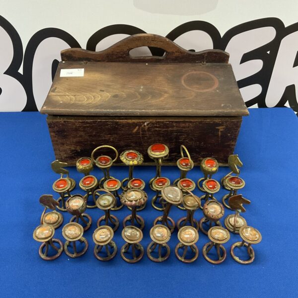 Vintage handcrafted chess pieces with unique sculpted tops.