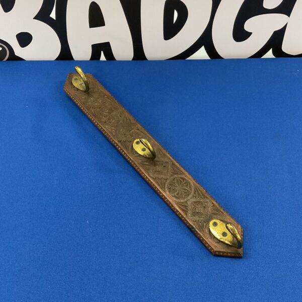 Antique Victorian coat hooks with floral embossed design.
