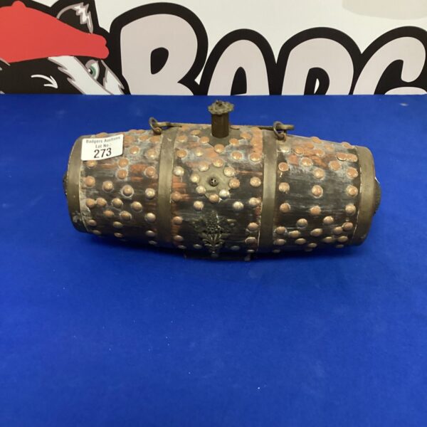 Vintage powder keg with metal bands and tap.