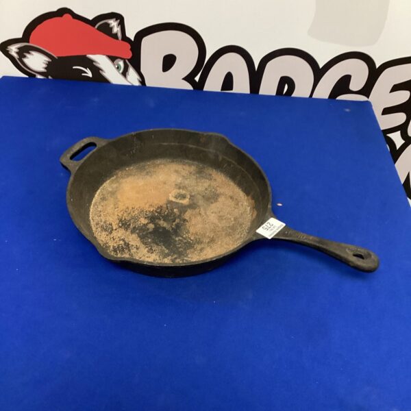 Vintage cast iron frying pan with seasoned surface.