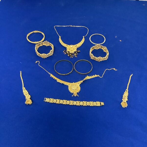 Close-up of a colourful Asian wedding jewellery set with a necklace and earrings.