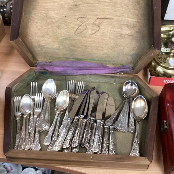Vintage silverplate cutlery set displayed in a wooden case.