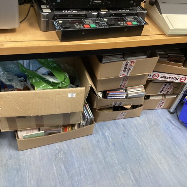 Stack of eleven boxes containing a large music CD collection.