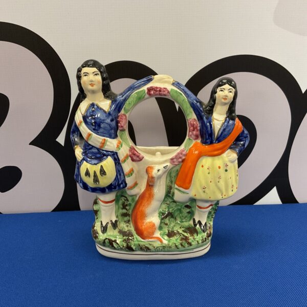 Antique Victorian Staffordshire pocket watch stand with gentleman figure.