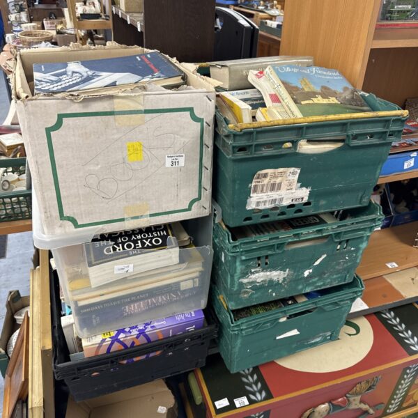 Six crates filled with assorted books and reading material.