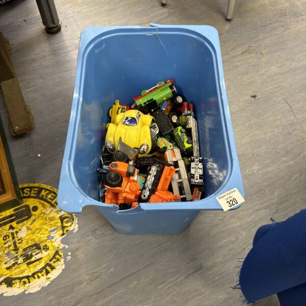 A bucket filled with a diverse lot of diecast toy cars.