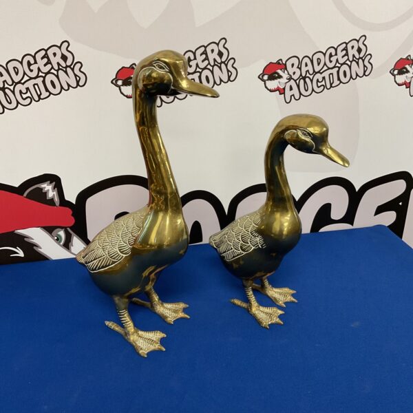 Pair of vintage brass geese statues for home decor.