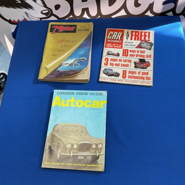 Vintage car show magazines from the 1950s, collectible automotive literature.