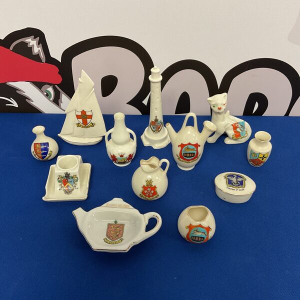 Overview of a crested ware collection featuring miniature ceramic pieces.