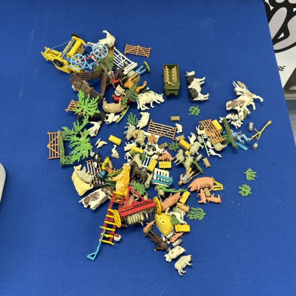 Vintage toy farm animals and vehicles lot for collectors.