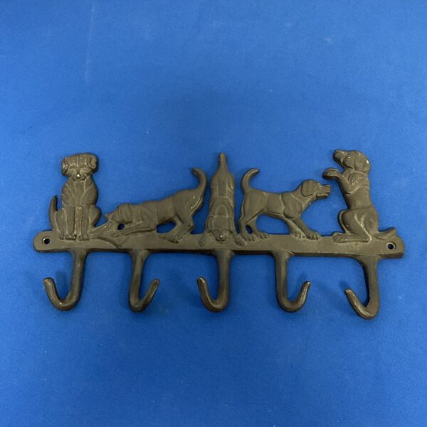 Vintage cast iron dog lead rack with four dog figures.
