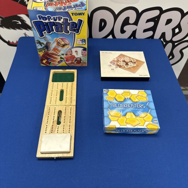 Board games lot featuring Pop Up Pirate and cribbage.