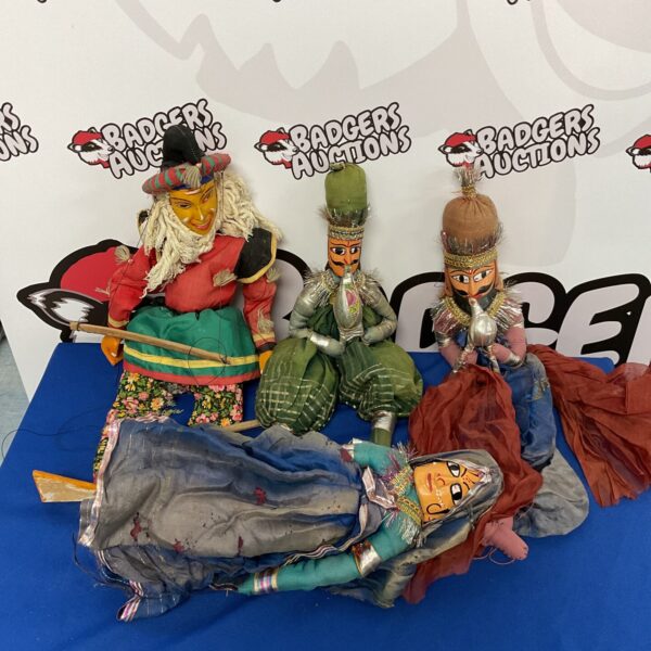 Lot of four antique Indonesian puppets with vibrant costumes.