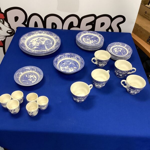 Vintage English Ironstone Willow Pattern pottery set on display.