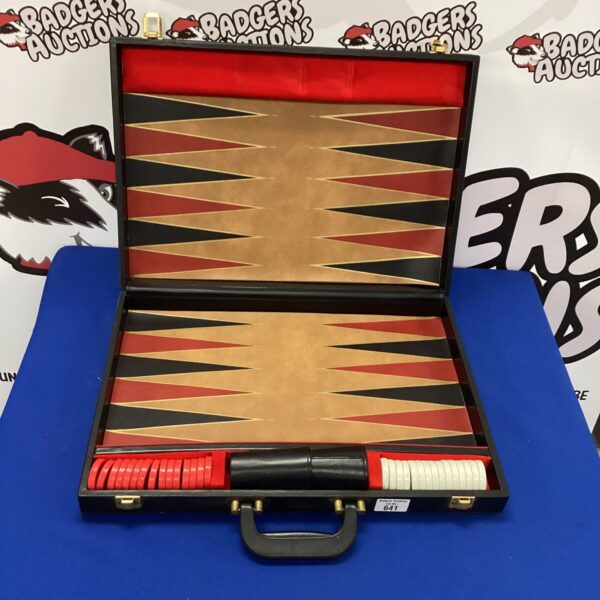 Vintage backgammon set in a worn leather case, classic board game.
