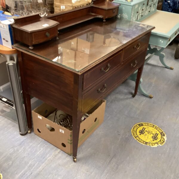 Antique Edwardian sideboard with glass top and mahogany finish.