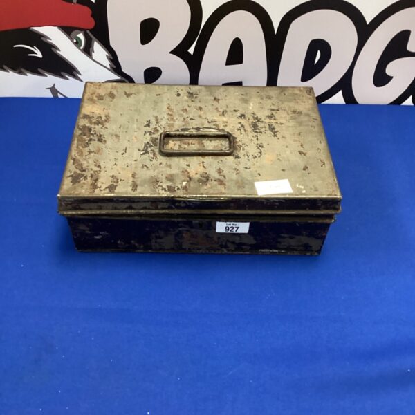 Front view of a vintage metal money box with coin slot.
