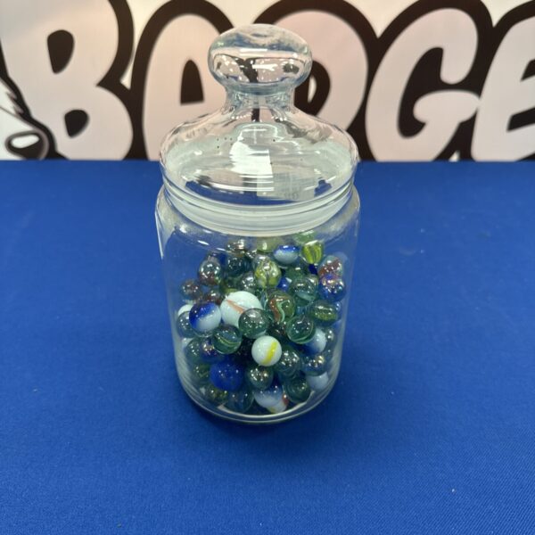 Clear glass jar filled with colourful vintage marbles.