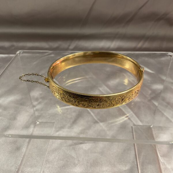 Intricate engraved vintage 9ct gold bangle, classic jewellery.