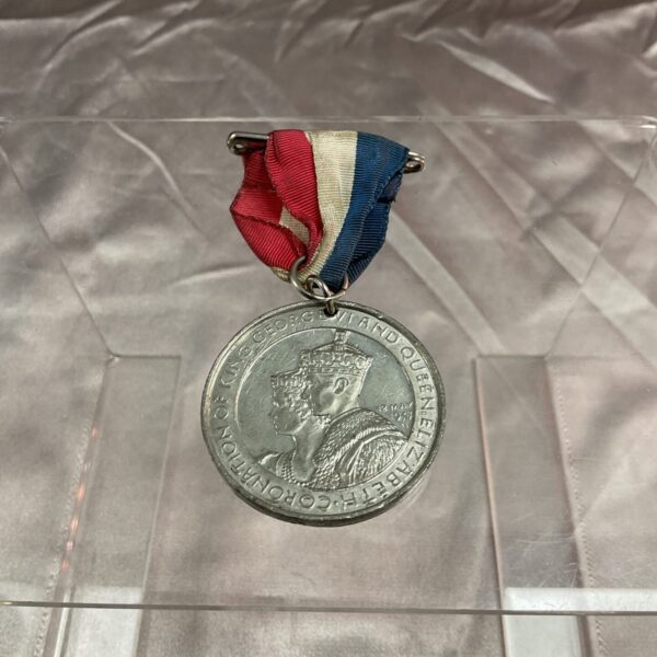 Front view of King George VI coronation medallion with ribbon.