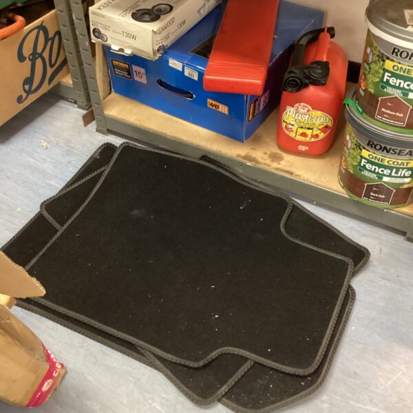 Single dark rubber car floor mat for vehicle protection.