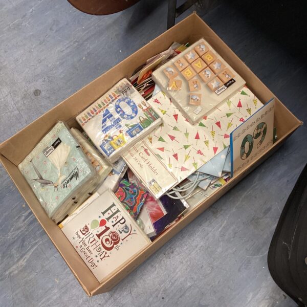 Assorted vintage birthday cards in a cardboard box.