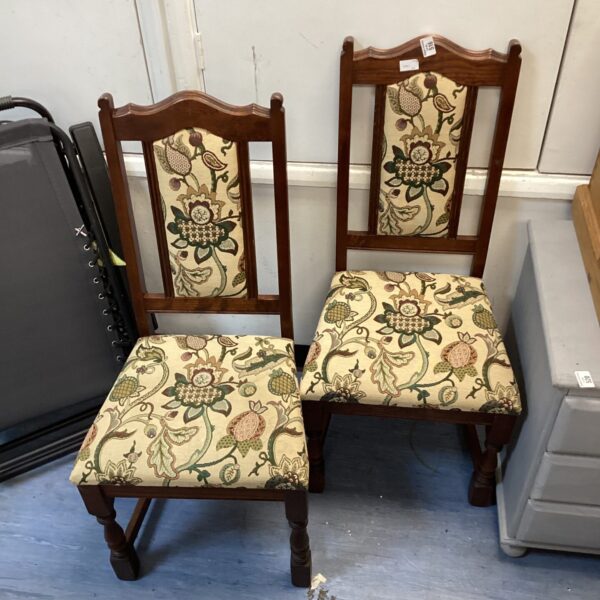 Vintage oak dining chairs with patterned upholstery in a home setting.