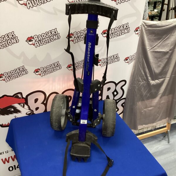 Purple Master Lite folding golf cart with three wheels.