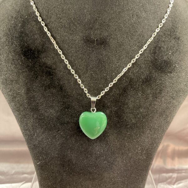 Green jade heart pendant necklace on a delicate chain.