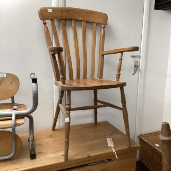 Antique pine carver chair with spindle back.