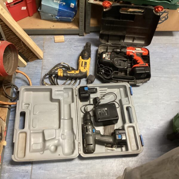 Cordless drill set with Dewalt hammer drill in carrying case.