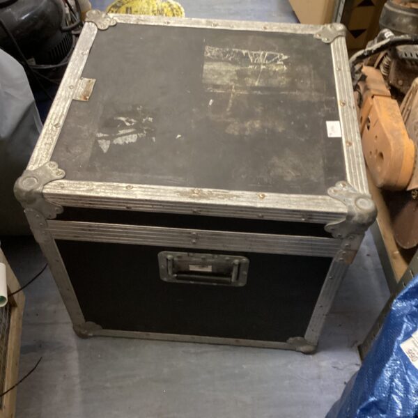 Front view of a square, worn travel case.