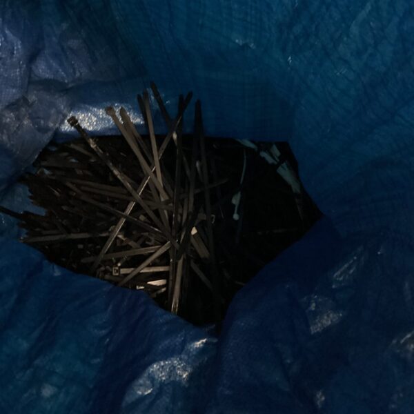Bulk lot of black plastic cable ties for wire management.