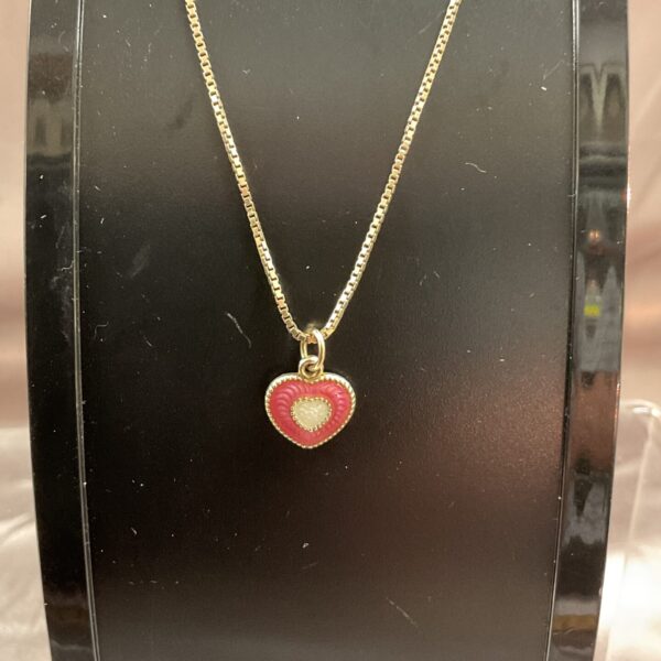 Vintage silver gilt and enamel heart pendant on a silver chain.