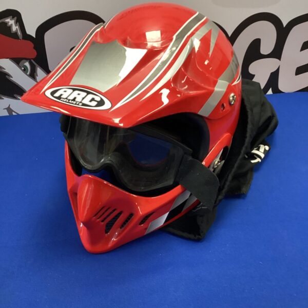 Red Arc motorcycle helmet with goggles for off-road riding.