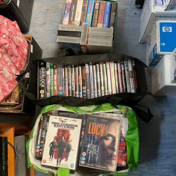 Mixed lot of DVDs and VHS films for collectors and movie fans.
