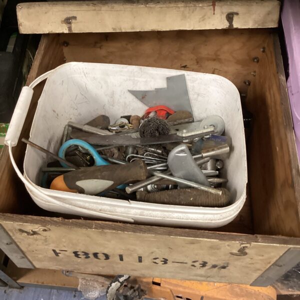 Mixed lot of vintage hand tools in a metal container.